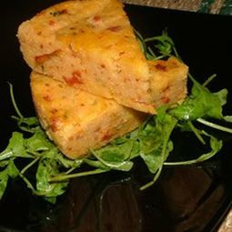 Parmesan polenta cake, olives and dried tomatoes