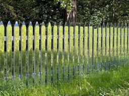 Mirror picket fence reflects the landscape