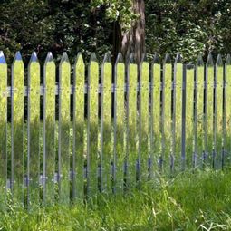 Mirror picket fence reflects the landscape