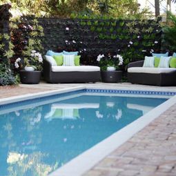 Vertical garden next to the swimming pool brings more green into your home