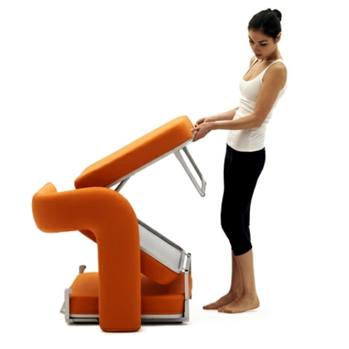 Orange armchair in single bed converted by Giulio Manzoni for Campeggi