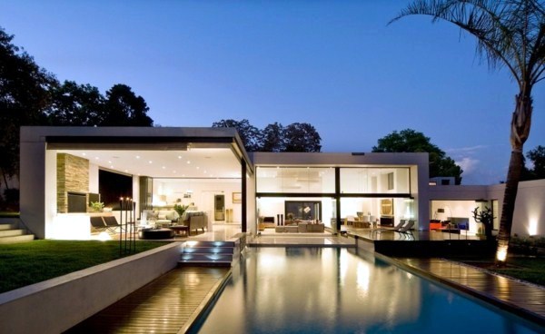 Contemporary prefab house in the Bauhaus style with glass facade and pool in the garden