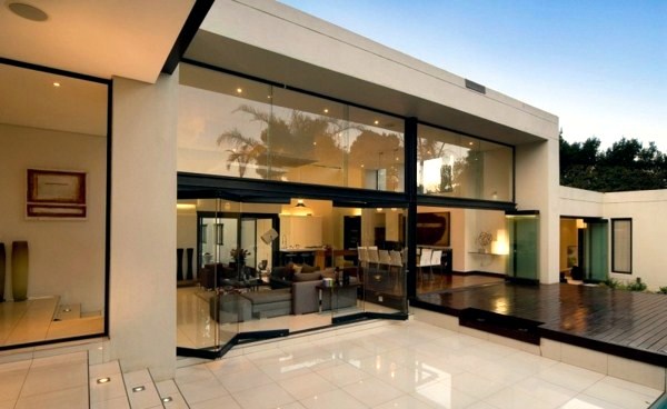 Contemporary prefab house in the Bauhaus style with glass facade and pool in the garden Contemporary prefab house in the Bauhaus style with glass facade and pool in the garden