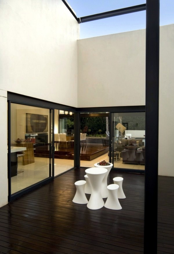 Contemporary prefab house in the Bauhaus style with glass facade and pool in the garden Contemporary prefab house in the Bauhaus style with glass facade and pool in the garden