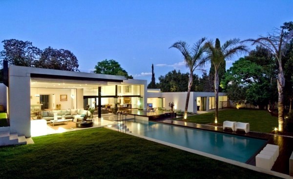 Contemporary prefab house in the Bauhaus style with glass facade and pool in the garden Contemporary prefab house in the Bauhaus style with glass facade and pool in the garden