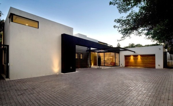 Contemporary prefab house in the Bauhaus style with glass facade and pool in the garden Contemporary prefab house in the Bauhaus style with glass facade and pool in the garden