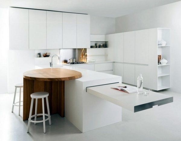 Minimalistic white kitchen with a dining area - by Elmar Studio