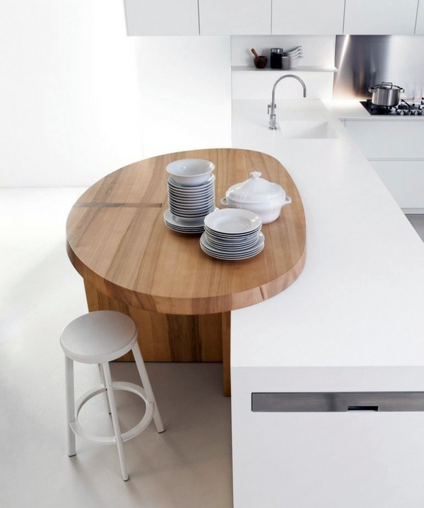 Minimalistic white kitchen with a dining area - by Elmar Studio