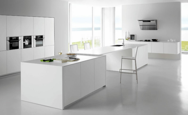 Minimalistic white kitchen with a dining area - by Elmar Studio