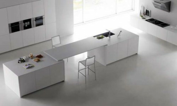 Minimalistic white kitchen with a dining area - by Elmar Studio