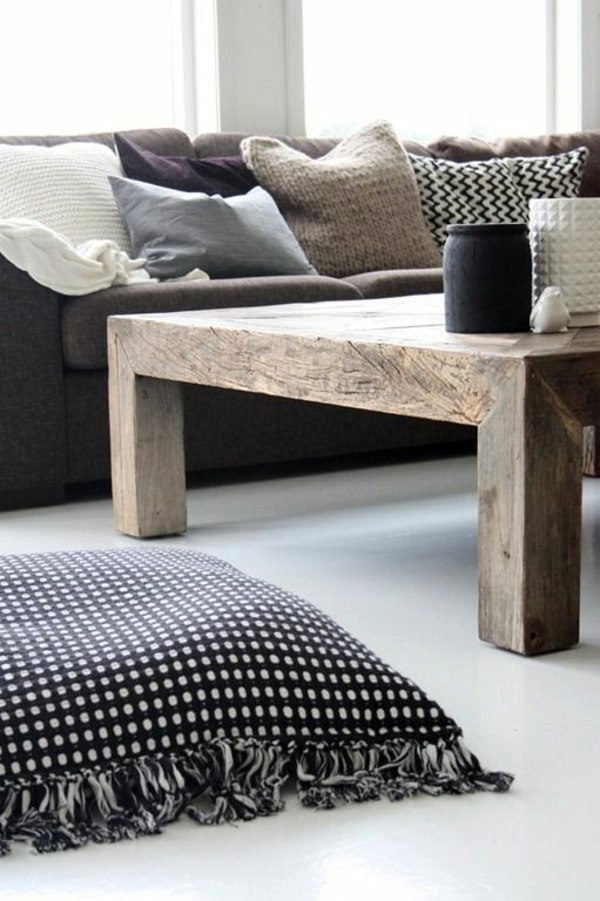A wooden coffee table in the living room adds warmth and naturalness in