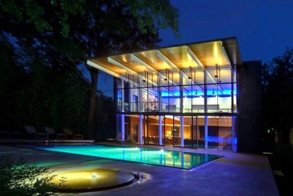 Modern house with windows and garden wall made of recycled glass