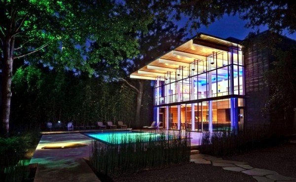 Modern house with windows and garden wall made of recycled glass