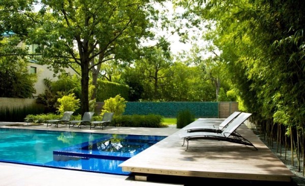 Modern house with windows and garden wall made of recycled glass