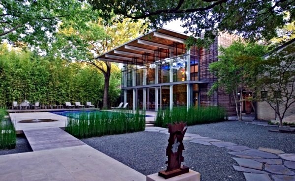 Modern house with windows and garden wall made of recycled glass
