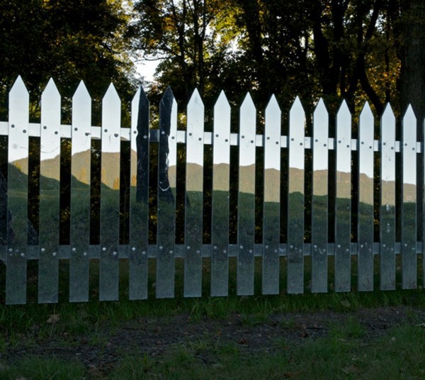 Mirror picket fence reflects the landscape