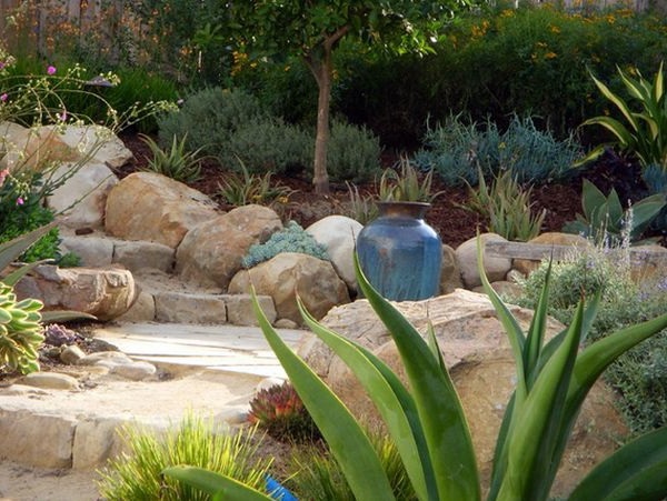 Install pebbles and river stones - beautiful landscape in the garden Install pebbles and river stones - beautiful landscape in the garden
