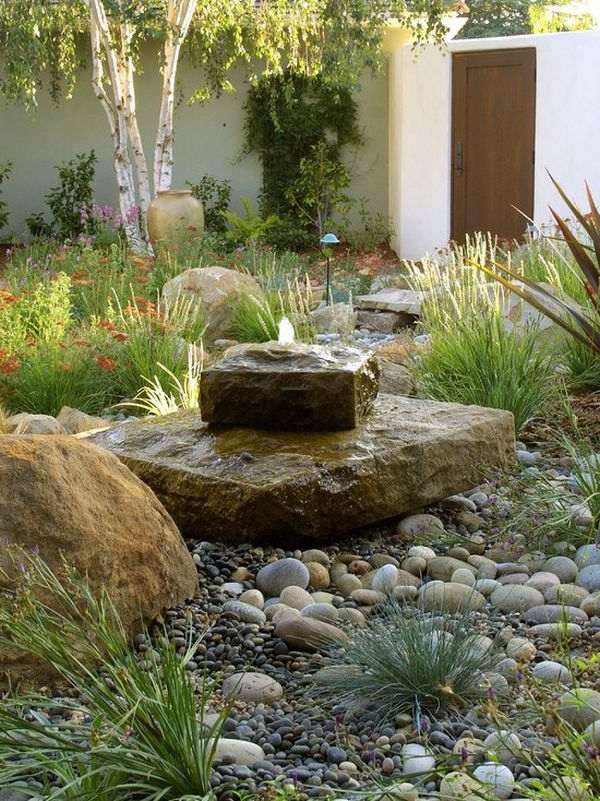 Install pebbles and river stones - beautiful landscape in the garden Install pebbles and river stones - beautiful landscape in the garden