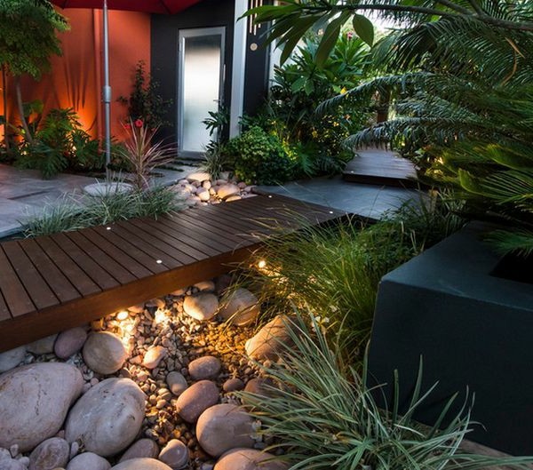 Install pebbles and river stones - beautiful landscape in the garden Install pebbles and river stones - beautiful landscape in the garden