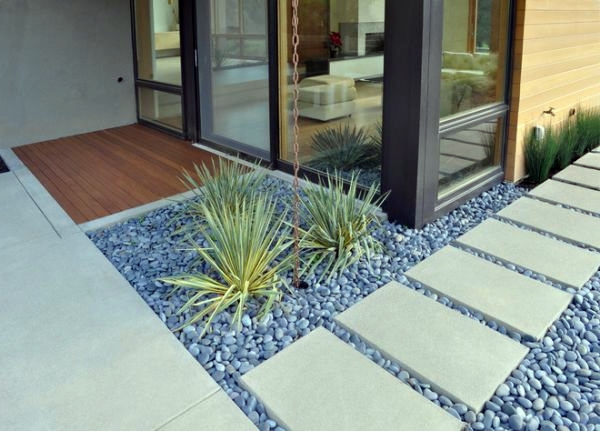 Install pebbles and river stones - beautiful landscape in the garden Install pebbles and river stones - beautiful landscape in the garden