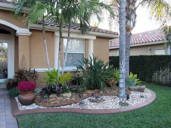 Install pebbles and river stones - beautiful landscape in the garden Install pebbles and river stones - beautiful landscape in the garden